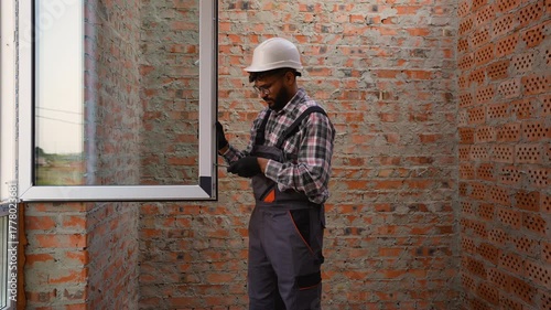Wallpaper Mural Professional construction worker installing a window frame Torontodigital.ca