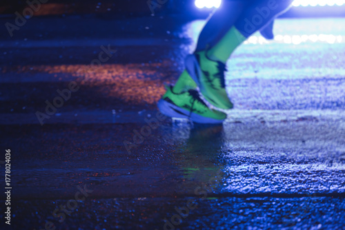 Photography Night marathon runners crowd in the rain, sportsmen participants start running t