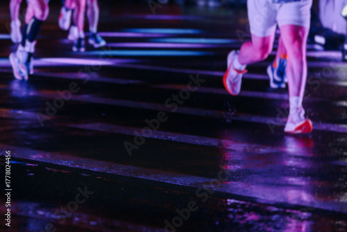Photography Night marathon runners crowd in the rain, sportsmen participants start running t