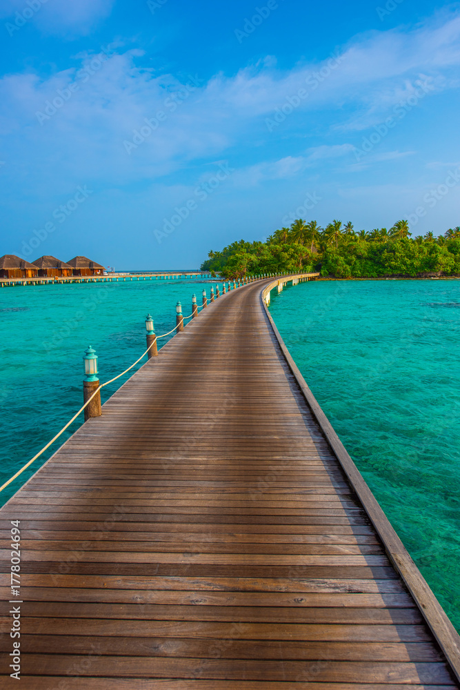 Fototapeta premium Tranquil closeup calm sea water waves with palm trees. Deck with bungalows. Tropical island beach landscape exotic shore coast. Summer vacation, holiday amazing nature. Relax paradise, Maldives.