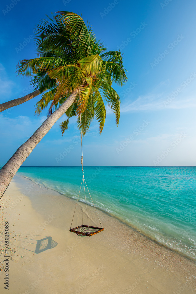 Fototapeta premium Tranquil closeup calm sea water waves with palm trees. Swing on the tree. Tropical island beach landscape exotic shore coast. Summer vacation, holiday amazing nature. Relax paradise, Maldives.