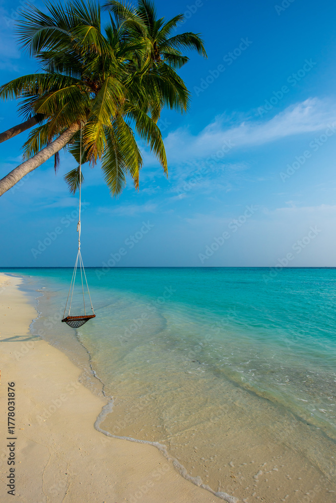 Fototapeta premium Tranquil closeup calm sea water waves with palm trees. Swing on the tree. Tropical island beach landscape exotic shore coast. Summer vacation, holiday amazing nature. Relax paradise, Maldives.