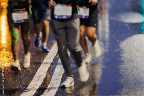 Photography Night marathon runners crowd in the rain, sportsmen participants start running t