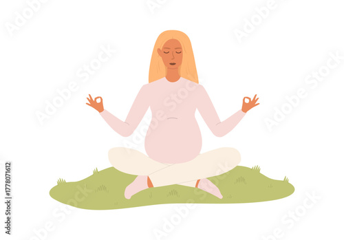 Pregnant woman doing yoga outdoors. She is sitting in the lotus position on the grass with her eyes closed, calm and relaxed. The concept of motherhood, mindfulness and a healthy lifestyle.