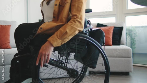 Close up of using a wheelchair for daily mobility and independence in a modern home setting