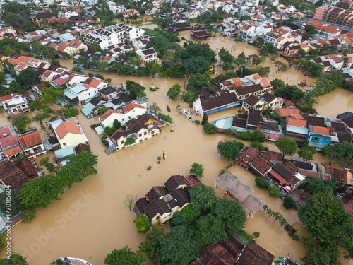 The deepest flood in history in Hoi An, Da Nang 2025. Aerial view of flooded ancient Asian town with yellow houses and brown roofs, showing severe urban flooding and climate disaster impact