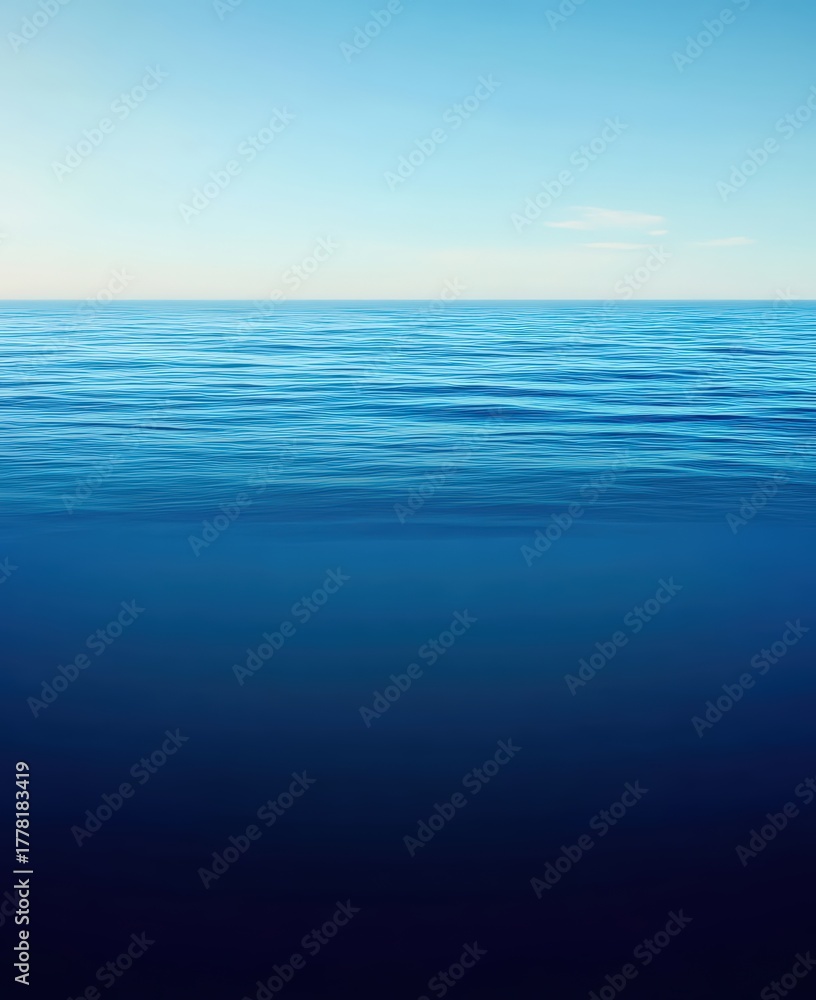 Obraz premium Calm ocean water surface extending to a clear horizon under a bright blue sky, creating a serene minimalist backdrop