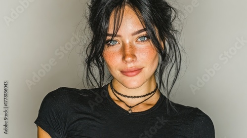 Beautiful Young Woman with Freckles Posing, Smiling and Looking at Camera
