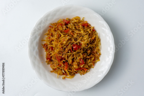 sambal teri, a popular Indonesian condiment made from crispy anchovies and a spicy chili paste, serve on white plate