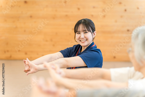 Young Asian female staff working at nursing home, welfare center (occupational therapist, stretcher, trainer)
