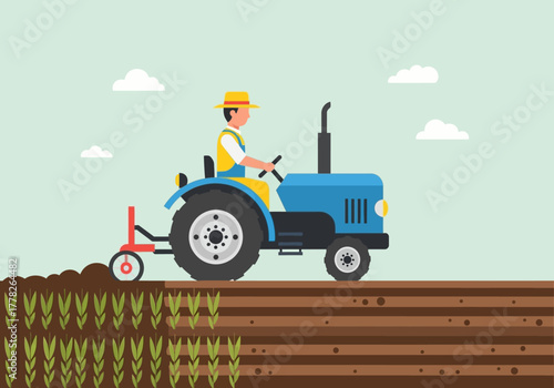 Farmer drives blue tractor plowing dark brown soil next to green sprouts