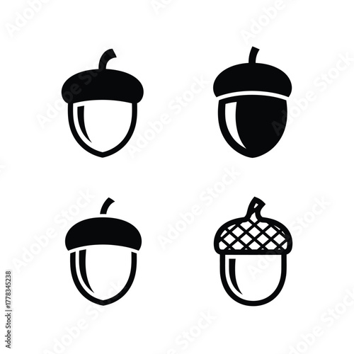 Set of four distinct minimalist black and white acorn icons, perfect for autumn, nature, and seasonal graphic design projects, offering clean, stylized vector representations of fall's essence