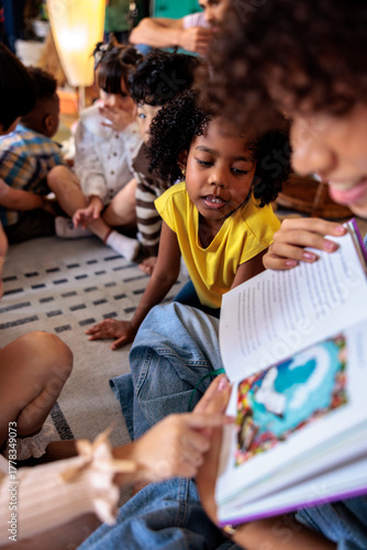 Story time, Children listen intently to a picture book.
