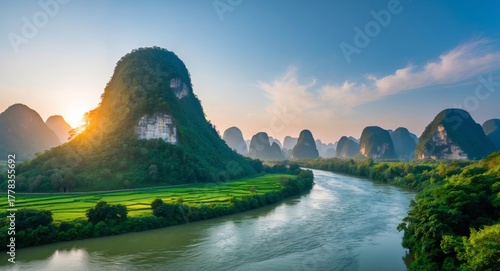 Serene Landscape of Limestone Karsts by River at Sunrise with Lush Greenery and Clear Blue Sky in Scenic Nature Vista