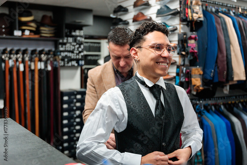 Smiling man getting fitted for a tailored suit vest
