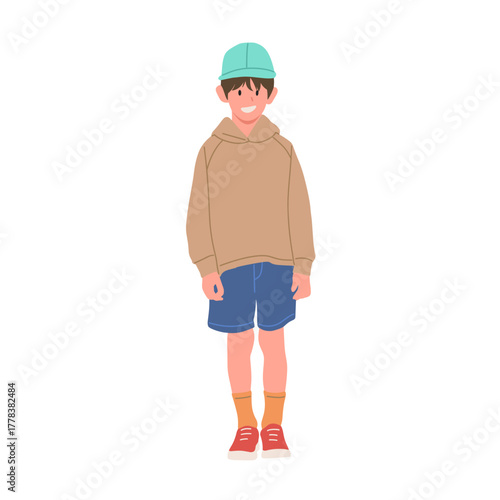 Smiling boy wearing brown hoodie, blue shorts, orange socks, red sneakers, and green cap. Cute child character illustration, isolated on white background, flat vector art style.