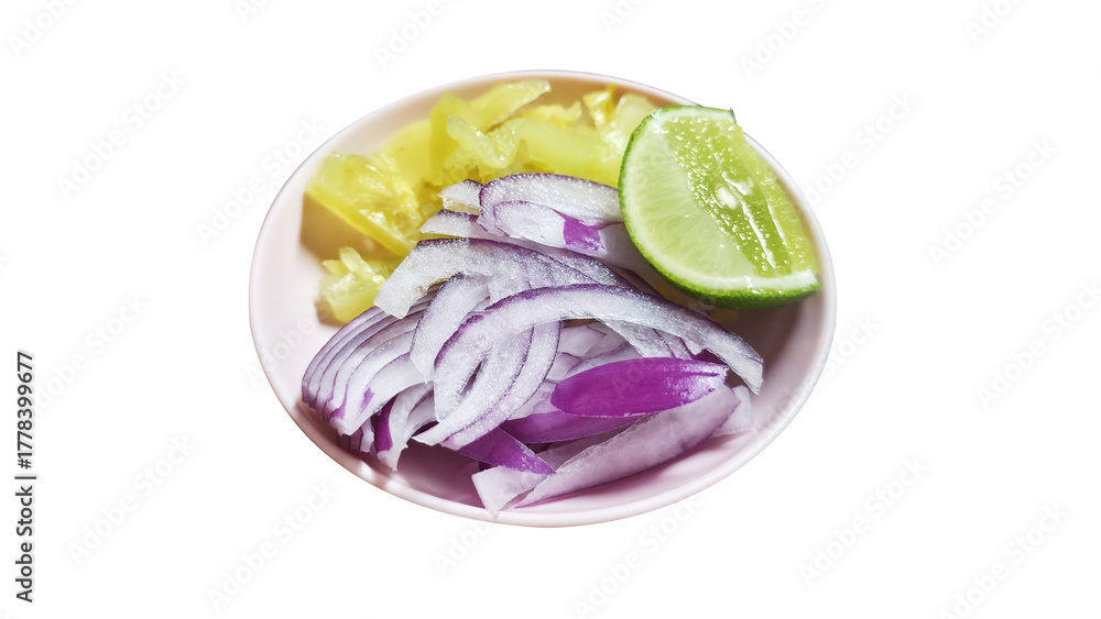 Fototapeta premium Close-up of a side dish with thinly sliced red onion, pickled mustard greens, and a fresh lime wedge, served as a condiment or garnish