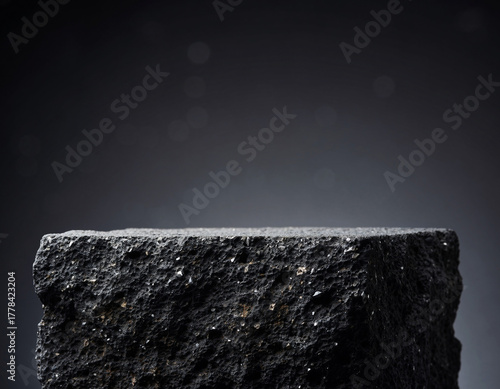 A black volcanic lava rock podium for product display