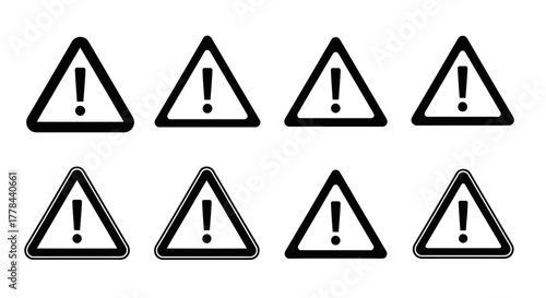 A series of black and yellow triangular warning signs with exclamation points