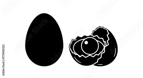 A whole egg and a cracked egg with an eye inside