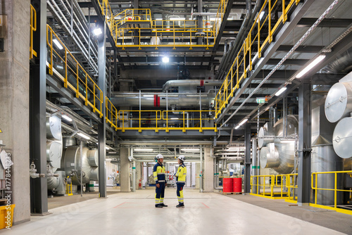 Workers Talking In Power Plant Workspace