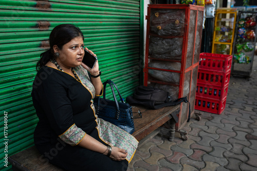 Indian woman talking in smartphone anxiously