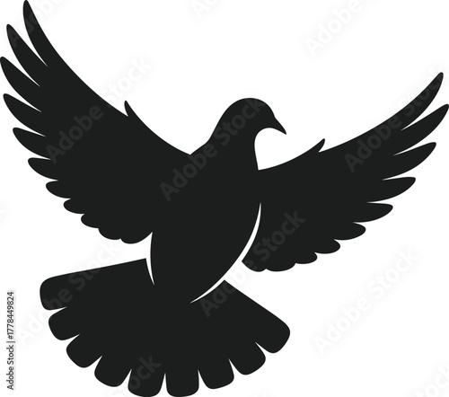 Black silhouette of a dove with wings spread wide in flight
