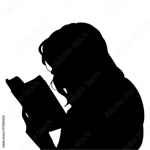 silhouette of a person reading a book