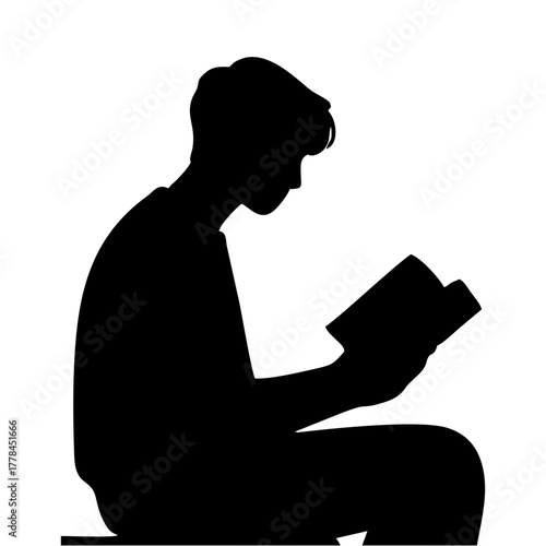 silhouette of a person reading a book