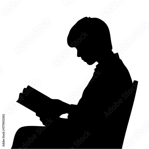silhouette of a person reading a book