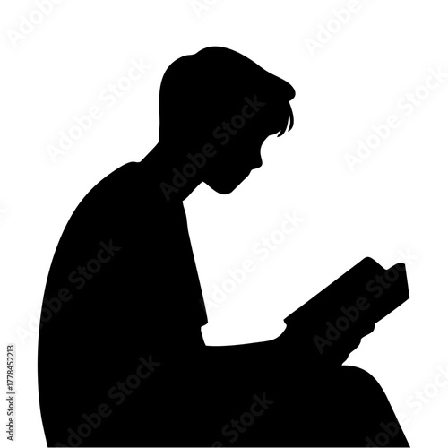 silhouette of a person reading a book