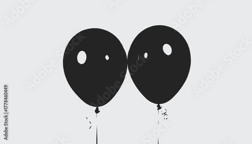 Silhouettes of two black balloons with white circular accents against a light gray background