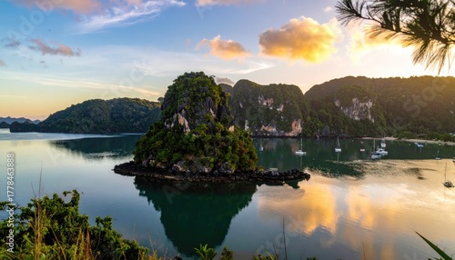 Serene Island Landscape at Sunrise with Calm Water Reflecting Golden Clouds and Verdant Hillsides
