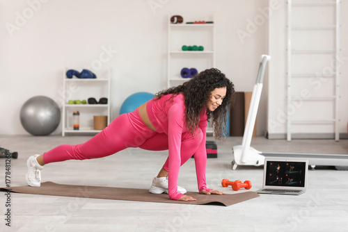 Young woman exercising at h...