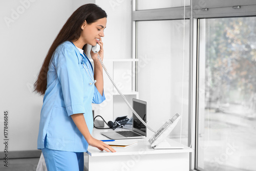 Young female doctor talking...