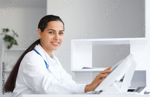 Young female doctor with te...