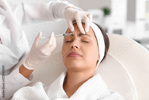 Young woman receiving foreh...