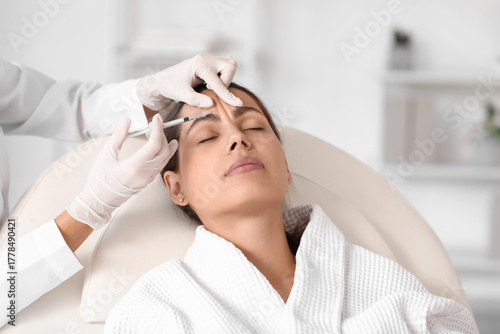 Young woman receiving foreh...