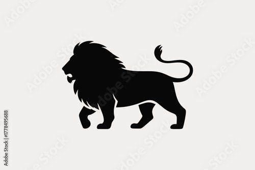 Silhouette of a majestic lion walking with its mane flowing