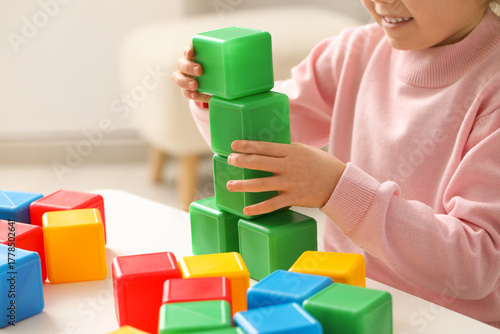 Cute little girl playing wi...