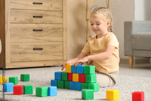 Cute little girl playing wi...