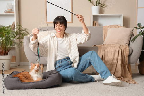 Young woman playing with cu...