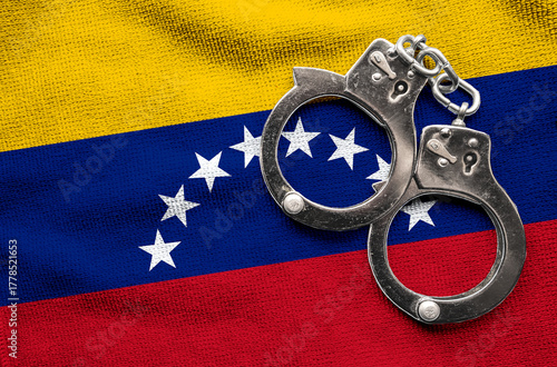 Flag of Venezuela and police handcuffs. Crime and offenses in country Concept
