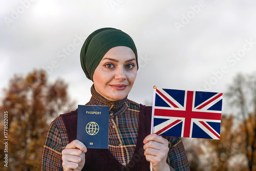 Muslim Woman Holding Passport and Flag of United Kingdom
