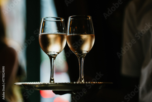 Two glasses of white wine on a tray