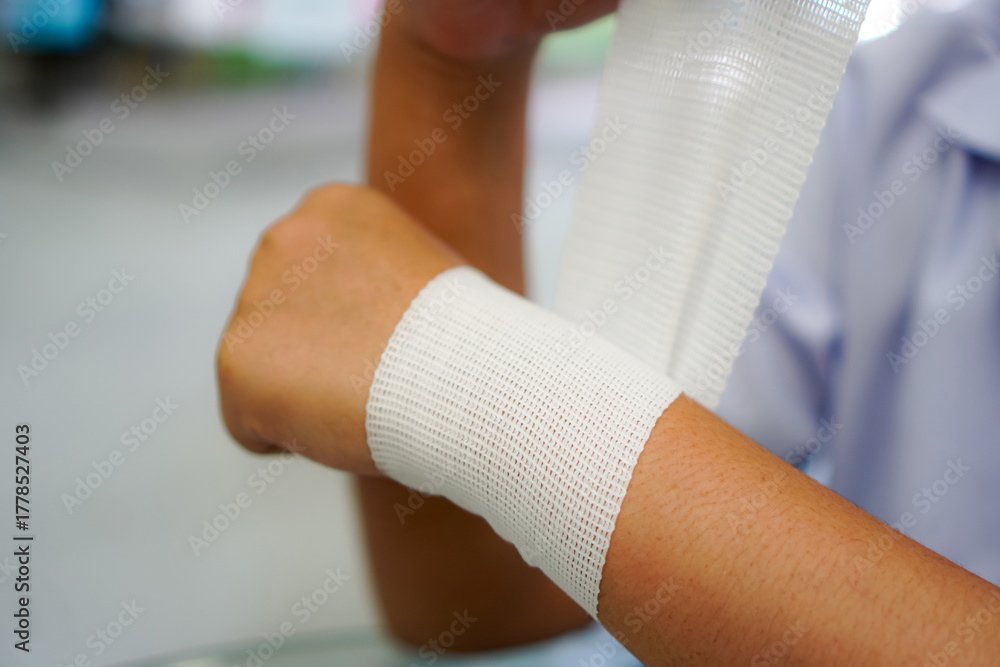 Obraz premium Elastic Bandage for Wrist Support Demonstrated by Physiotherapist