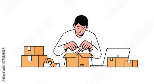 A man in a white shirt packing a cardboard box at a table with stacked boxes and a laptop.