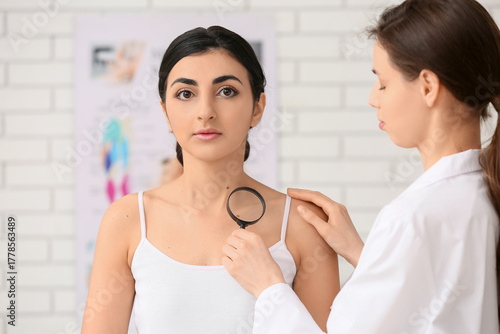 Dermatologist with magnifyi...