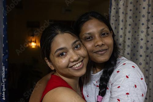 Two Young Indian lady looking at camera inside home, close up shot