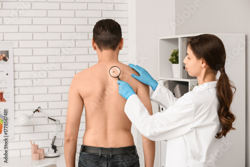 Dermatologist with magnifyi...